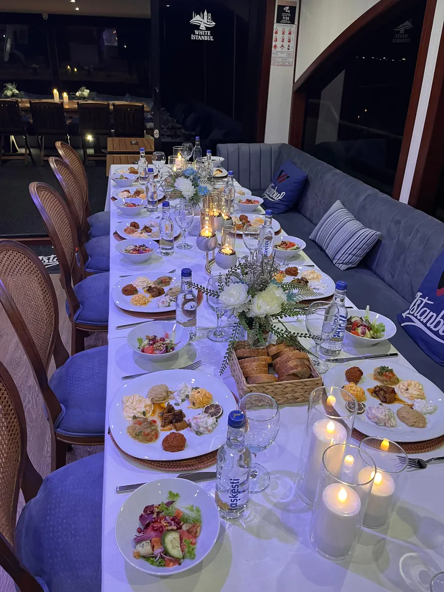 Candlelit New Year dinner table on a yacht